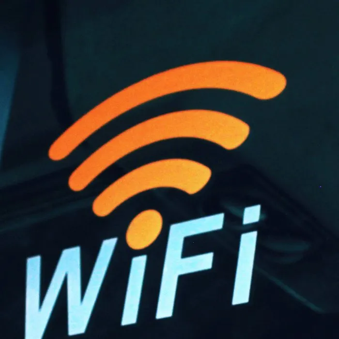 Ein leuchtendes Wi-Fi-Schild an einer dunklen Wand